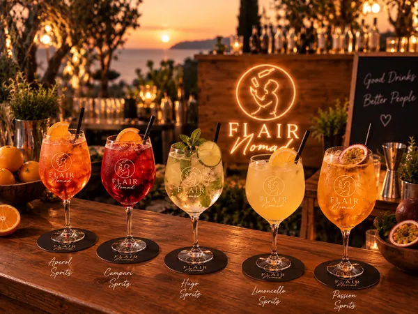 Aperol, Campari, Hugo y Limoncello Spritz servidos en copa de balón frente al mar al atardecer